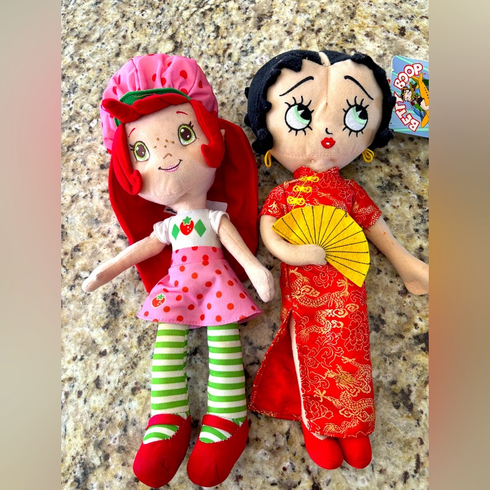 Two vintage dolls. One is‎ brand new the strawberry shortcake is not